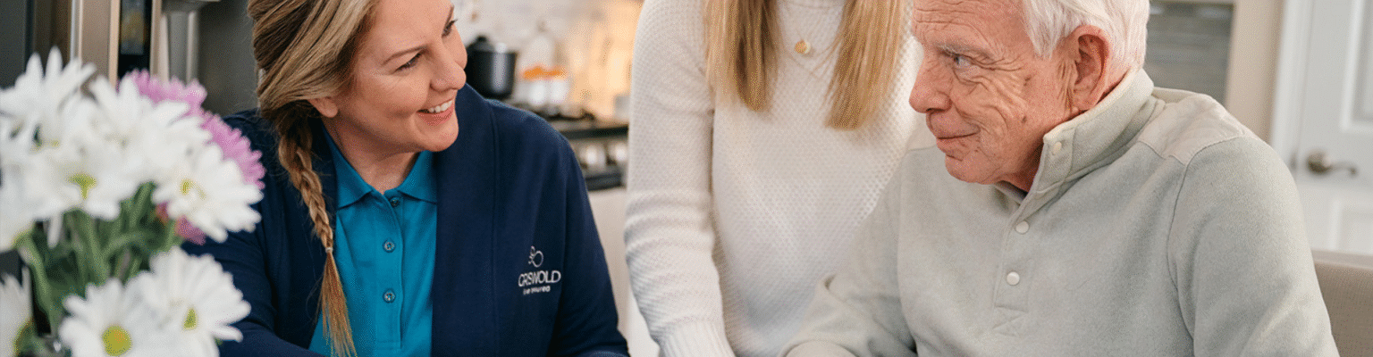 A Griswold employee sitting with an elderly man