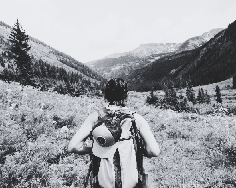 work from anywhere - woman with a backpack walking in nature