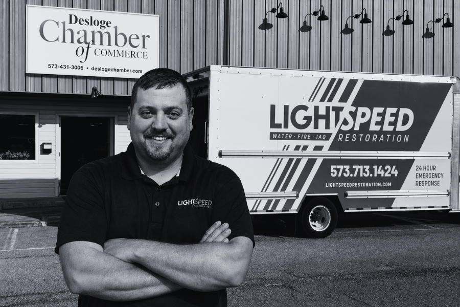 Mark Curfman, Lightspeed Restoration franchisee, standing in front of a truck